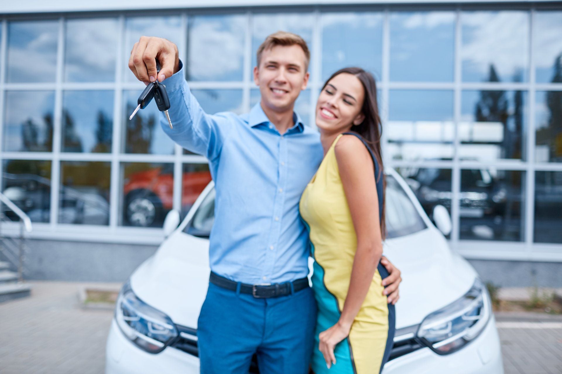 stock photo proud owners beautiful young happy couple hugging standing near their newly bought car smiling 720541084